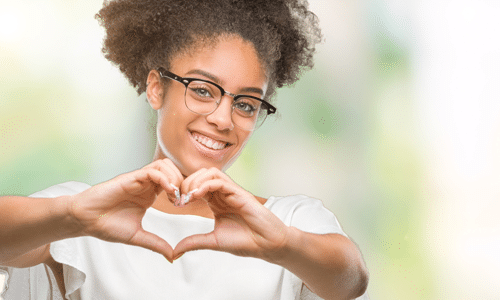 woman making heart shape with hands