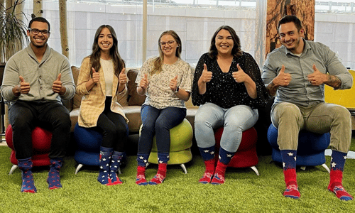 people sitting in a row with spirit sox socks on