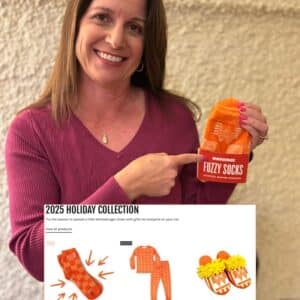 Lisa holding a pair of Spirit Sox custom socks with a graphic call out for the company's 2025 holiday collection