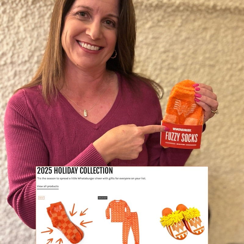 Lisa holding a pair of Spirit Sox custom socks with a graphic call out for the company's 2025 holiday collection