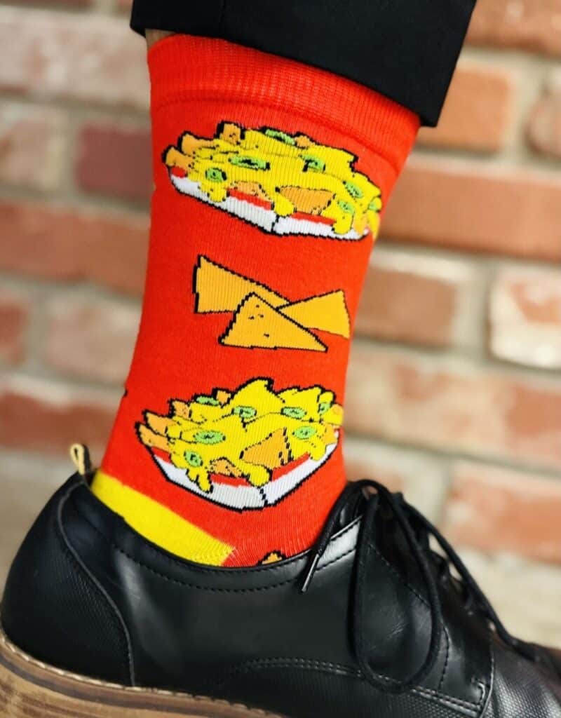 someone wearing a pair of custom design crew socks with nacho graphics