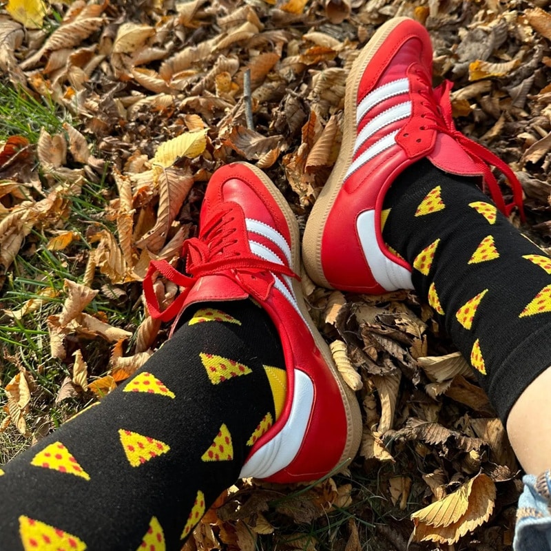 a pair of black custom crew socks with pizza pattern