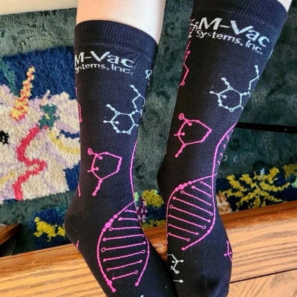 a pair of custom branded corporate socks for M Vac systems with DNA sequences