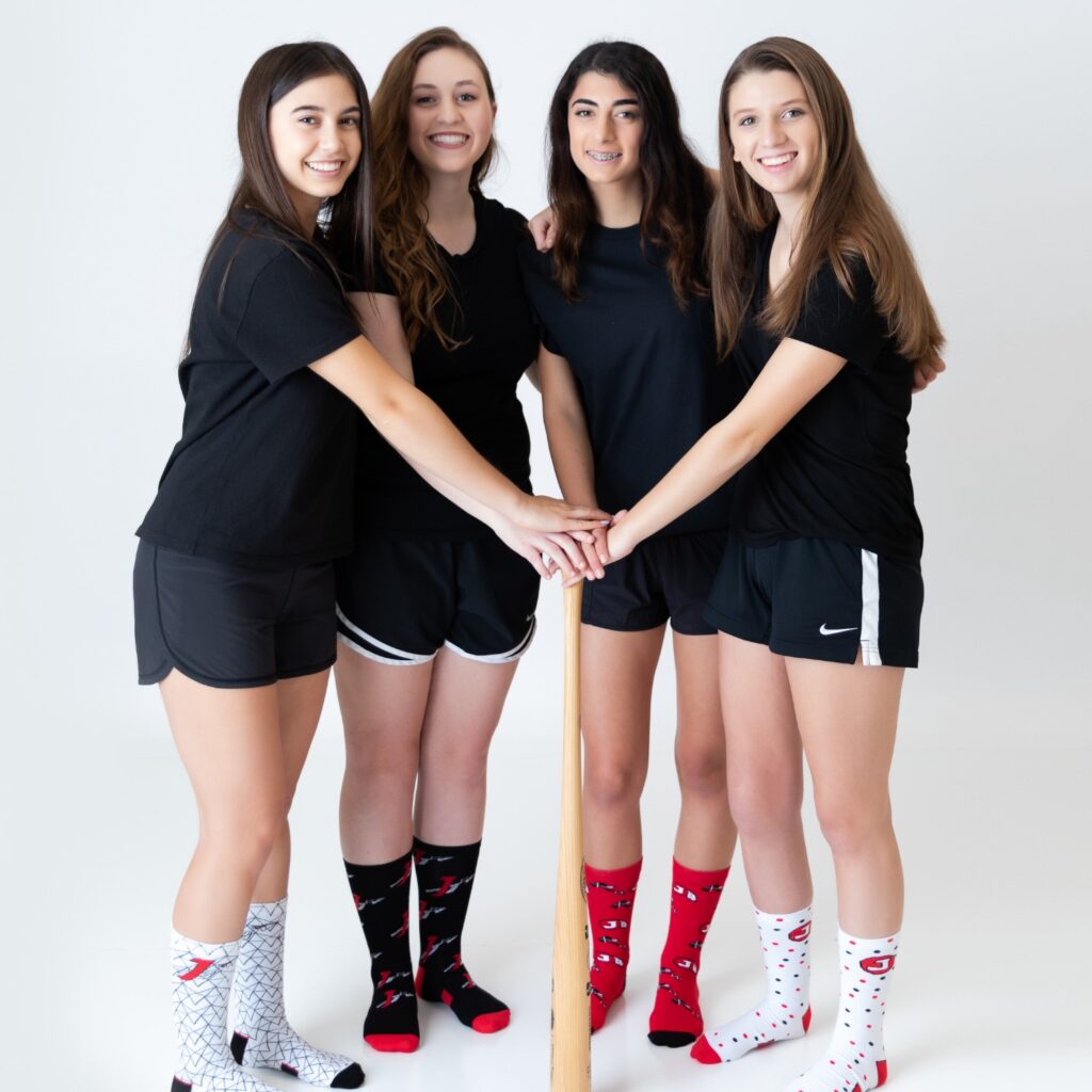 white, red, and black patterned custom socks for women's baseball from spirit sox