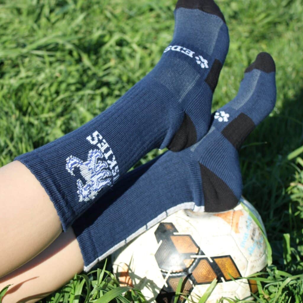 a blue pair of custom logo socks with white logo and slogan