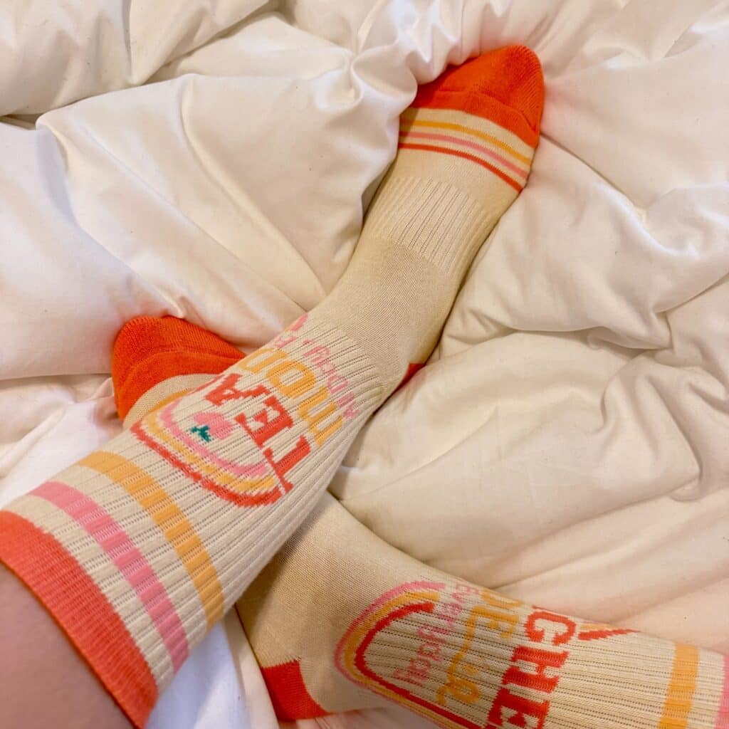 orange and white custom socks with minimalist cute brand logo