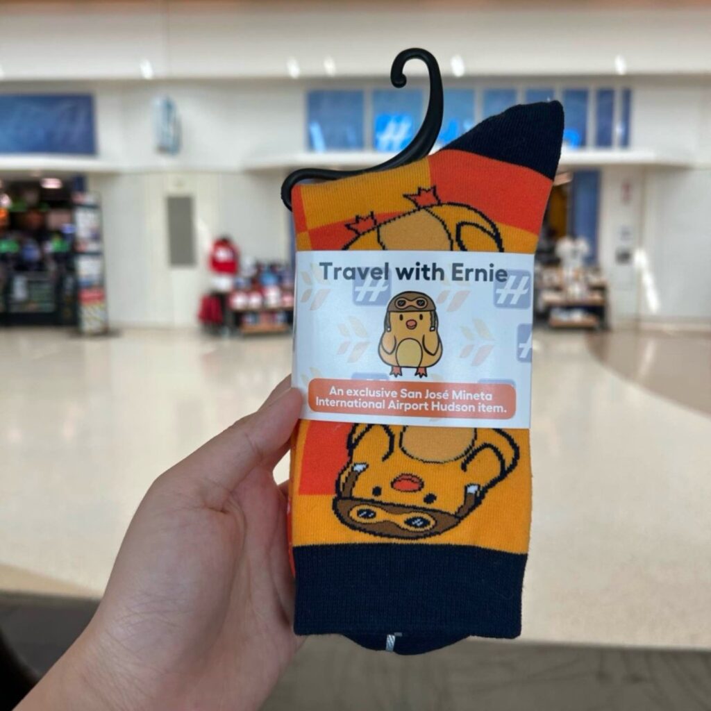 a pair of custom socks with travel with earnie logo and little yellow duck mascot