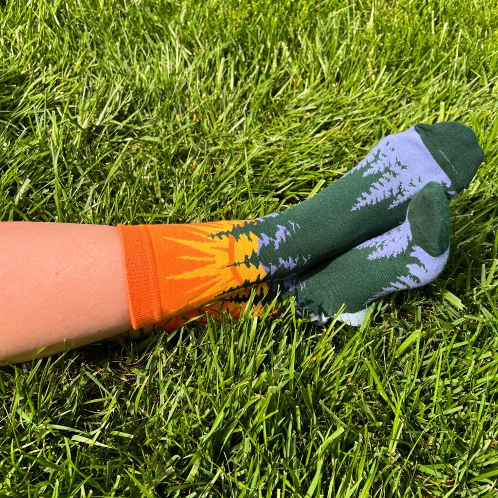 customized socks by spirit sox featuring woods and sunset