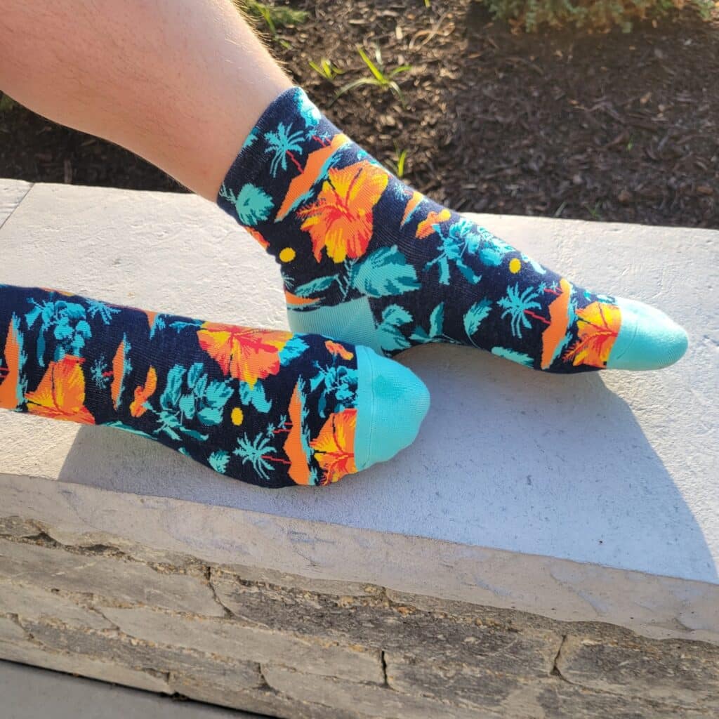 custom athletic socks with blue and orange pattern on black background