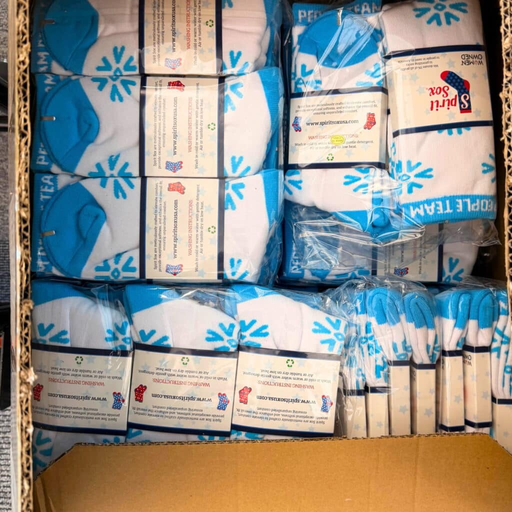 a box of custom knitted socks with snowflake design by spirit sox usa