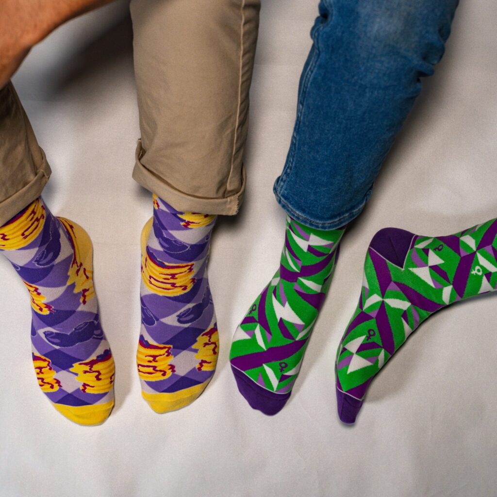 branded corporate socks with abstract patterns on the right and pancakes design on the left