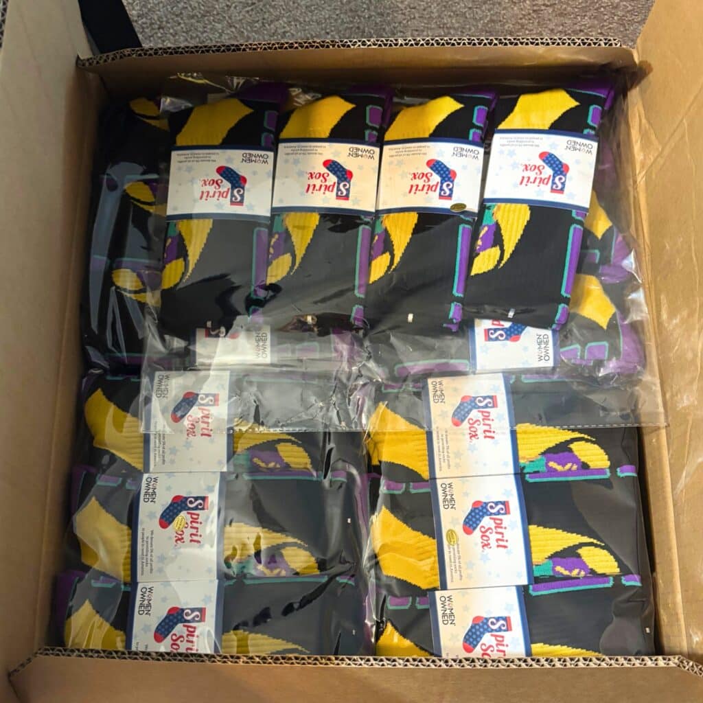 a box of branded corporate swag socks from spirit sox with separate packaging