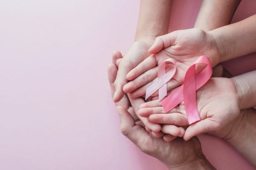 women holding pink ribbons