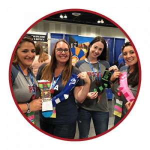 PTA moms holding up their custom socks by Spirit Sox USA