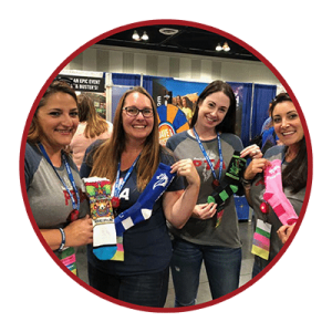 PTA moms holding up their custom socks by Spirit Sox USA