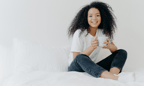 woman drinking tea and smiling