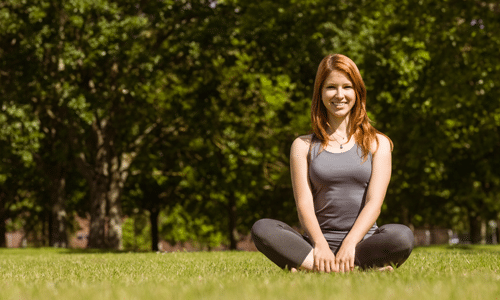 woman doing yoga in field